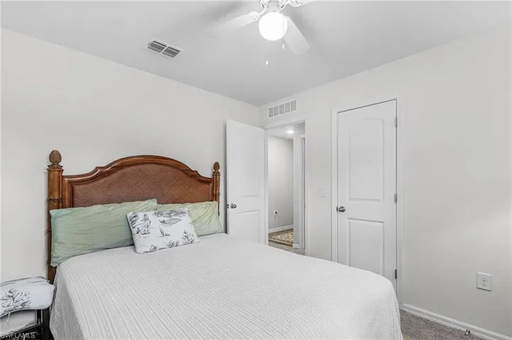 Carpeted bedroom featuring baseboards and a ceiling fan
