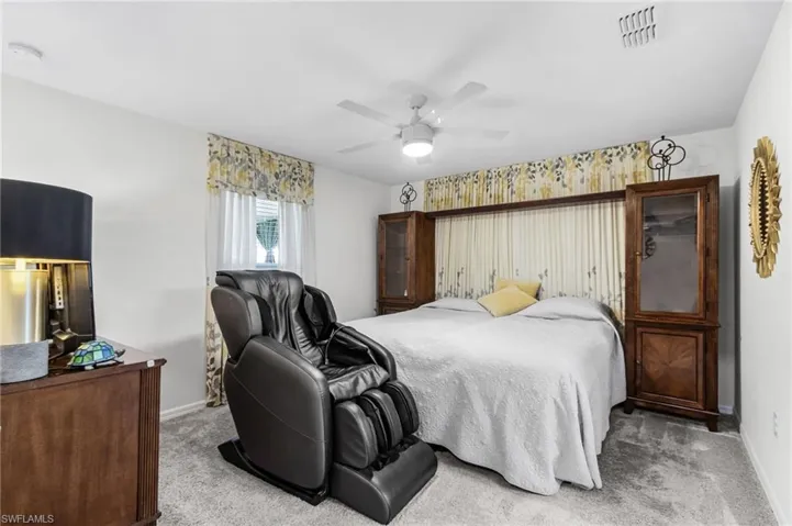 Bedroom featuring light colored carpet and ceiling fan