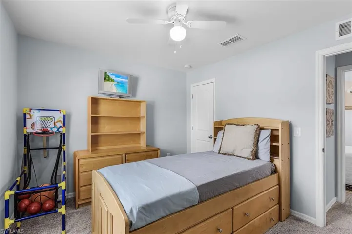 Bedroom featuring light carpet and ceiling fan