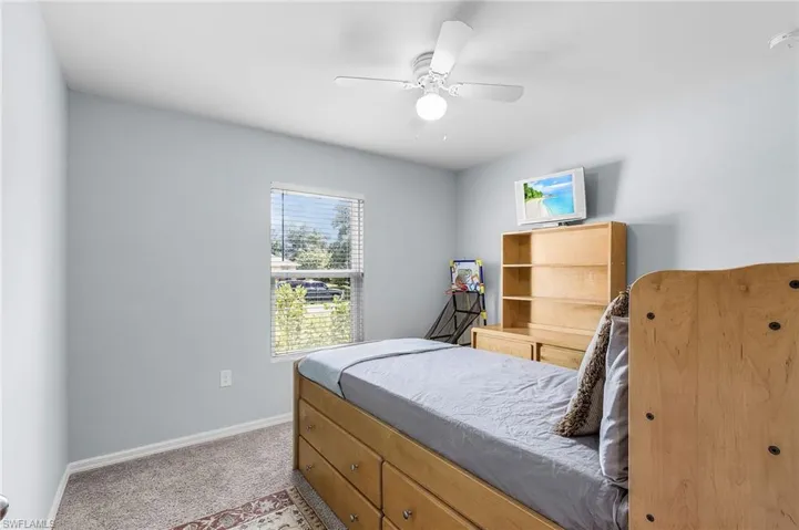 Bedroom featuring light colored carpet and ceiling fan