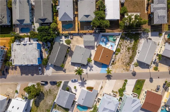 Aerial property overview featuring multiple residential structures and a street