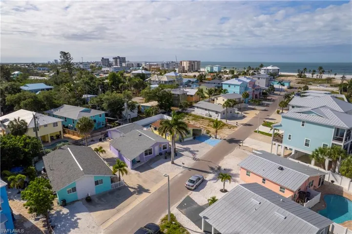 Coastal neighborhood featuring a variety of single-family homes, some with elevated foundations