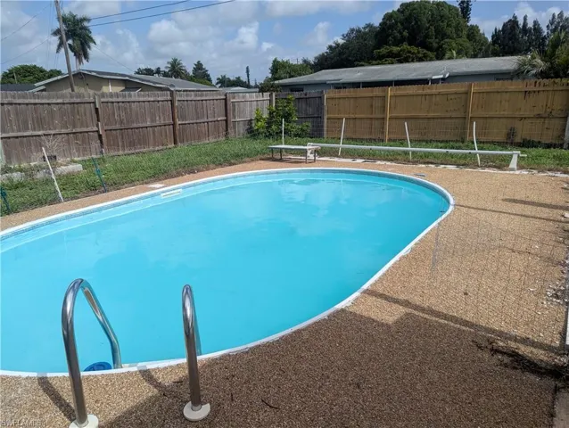 View of swimming pool with a fenced backyard