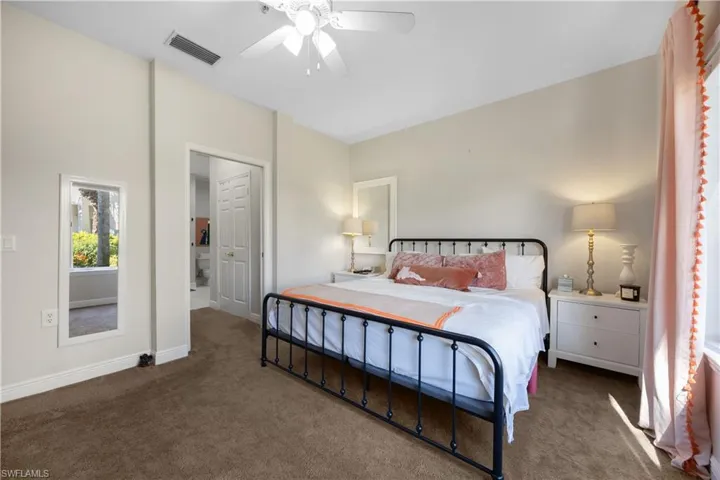 Bedroom featuring ceiling fan and dark colored carpet