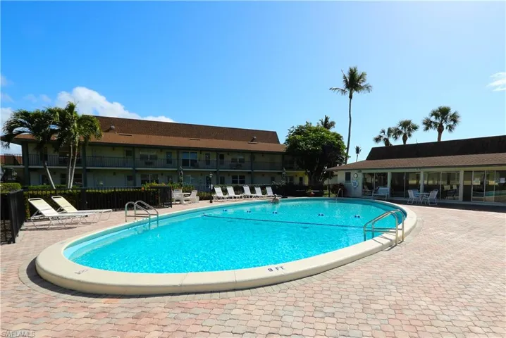 Community pool with a patio