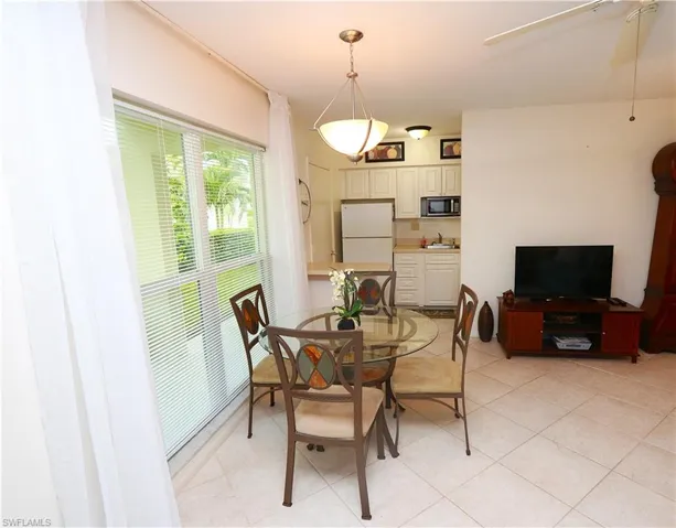 Dining room featuring ceiling fan and light tile patterned floors