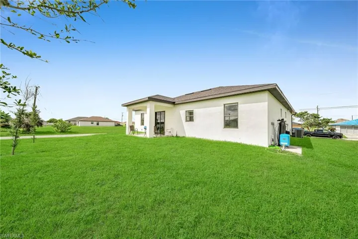 Back of house featuring a lawn
