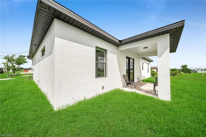 Rear view of property featuring a patio area and a yard