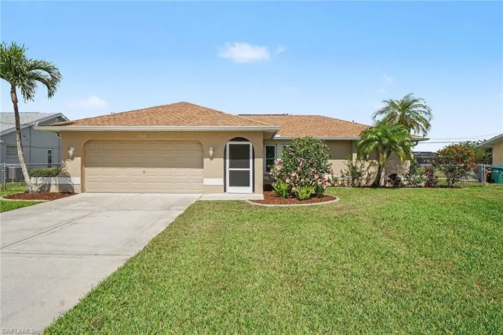 Ranch-style house featuring stucco siding, an attached garage, and concrete driveway