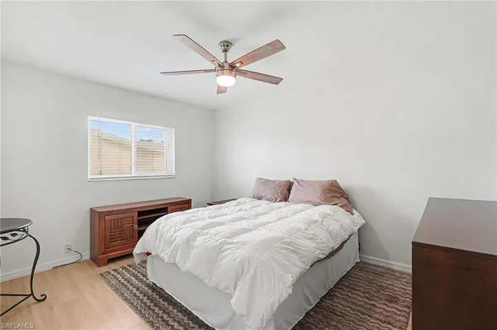 Bedroom with baseboards and a ceiling fan