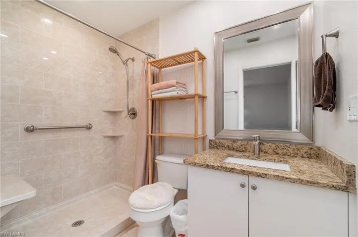 Bathroom with vanity and a stall shower