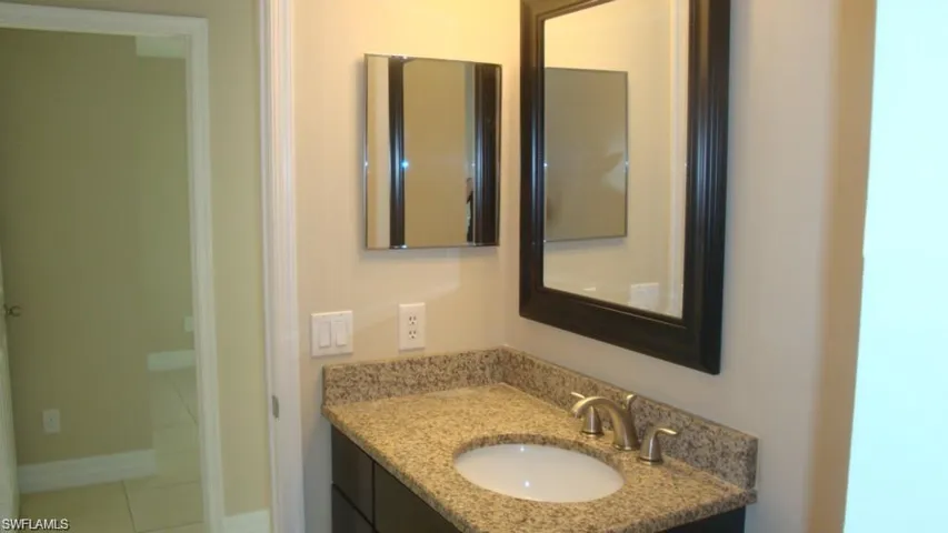 Bathroom with vanity and tile patterned floors