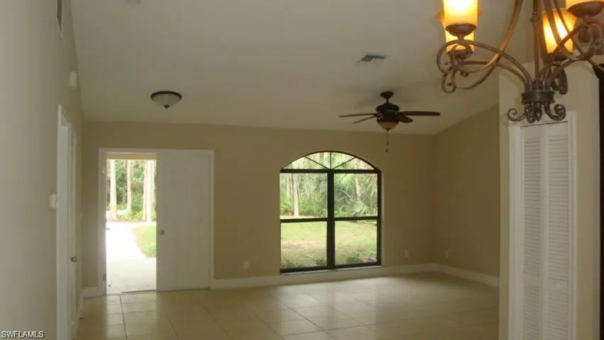 Spare room featuring light tile patterned floors and ceiling fan