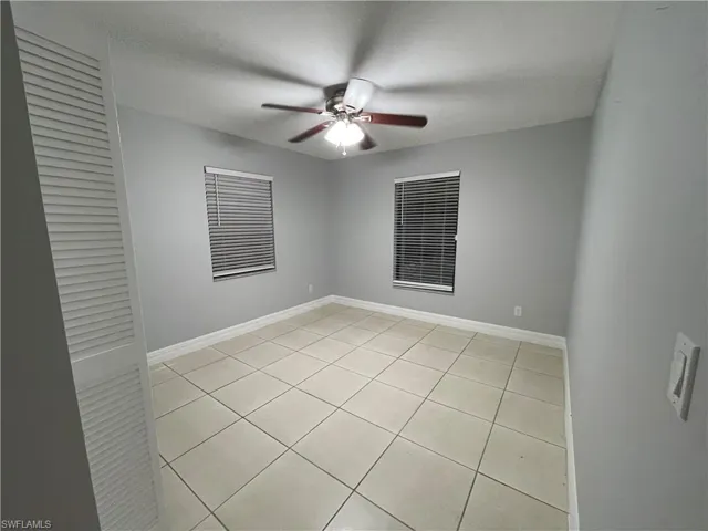 Unfurnished room featuring light tile patterned floors, a textured ceiling, and a ceiling fan