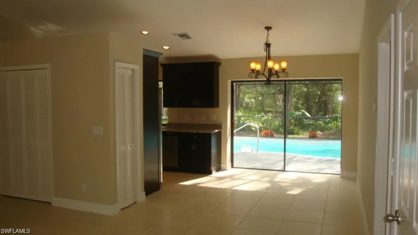 Unfurnished dining area featuring a chandelier, recessed lighting, and light tile patterned flooring