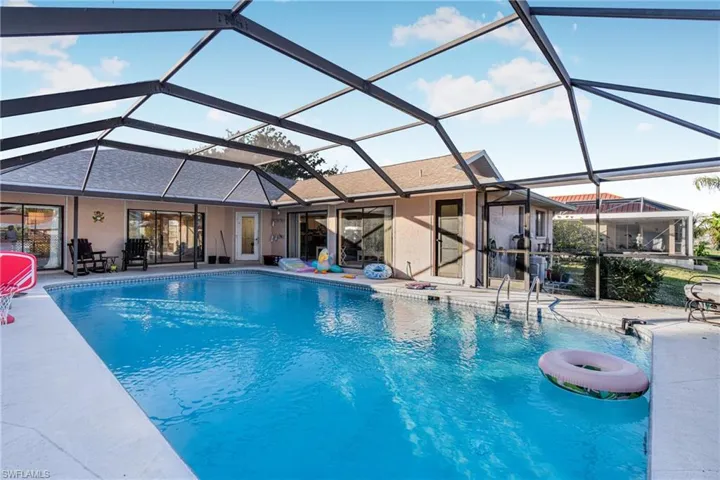 View of swimming pool featuring a lanai and a patio area