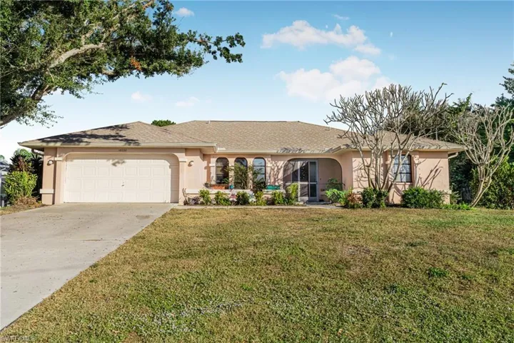 Ranch-style home with a garage and a front yard