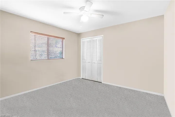 Unfurnished bedroom featuring carpet flooring, a closet, and ceiling fan