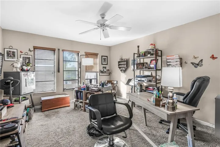 Carpeted office space with ceiling fan