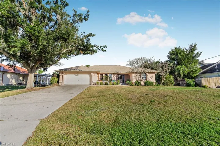 Single story home with a front lawn and a garage