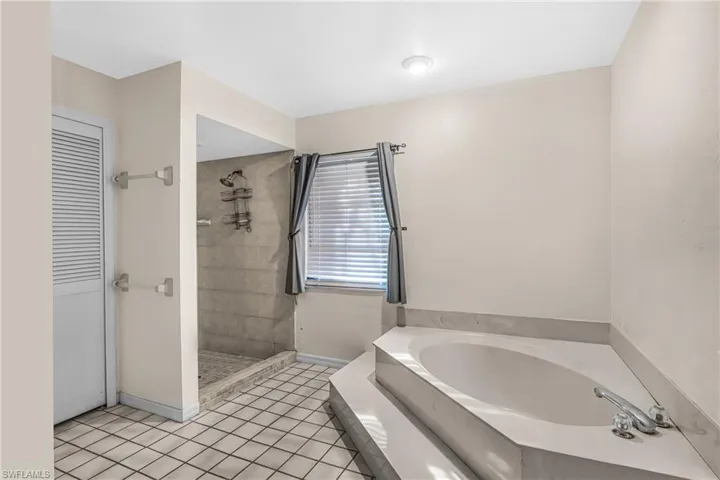 Bathroom featuring tile patterned floors and separate shower and tub