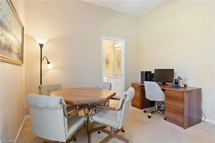 Office with light carpet and baseboards