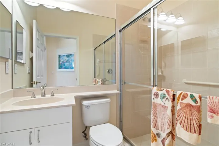 Bathroom featuring vanity and a shower stall