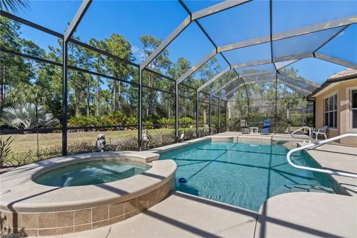 Combined pool / hot tub featuring a patio, a sunroom, and a lanai