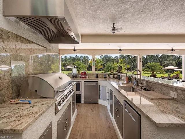 View of patio with a grill, ceiling fan, sink, and area for grilling