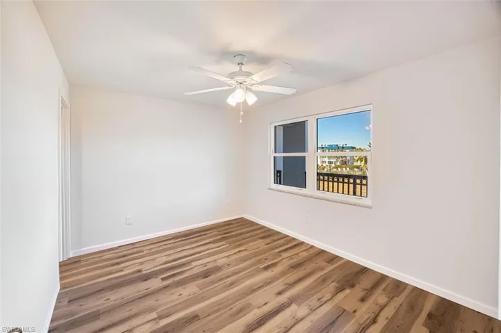 Unfurnished room featuring wood finished floors and ceiling fan