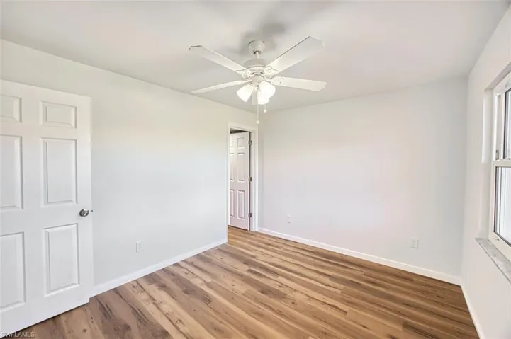 Unfurnished bedroom featuring ceiling fan and wood finished floors
