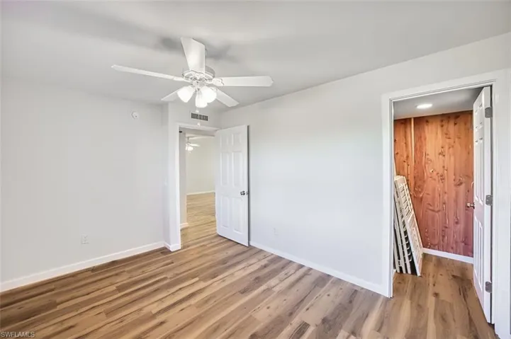 Unfurnished bedroom with wood finished floors, ceiling fan, and recessed lighting
