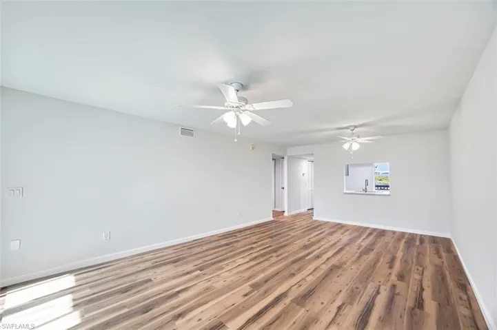 Empty room with wood finished floors and ceiling fan