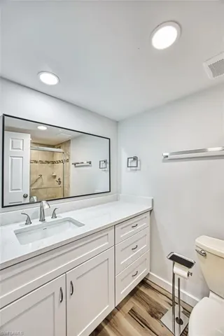 Bathroom with a shower stall, vanity, and light wood-style floors