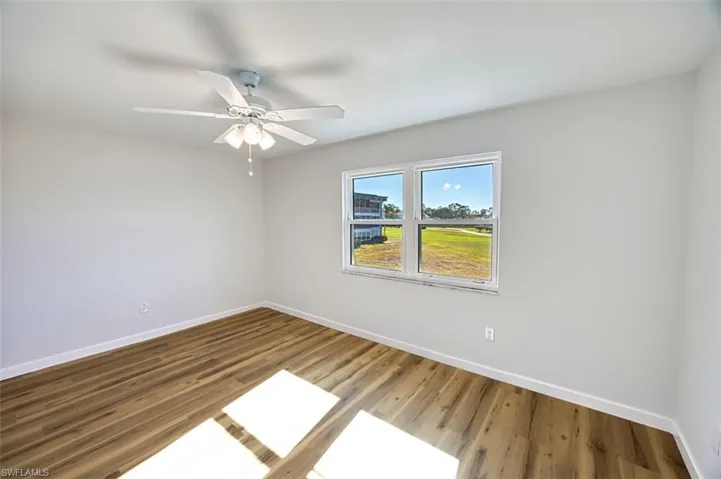 Spare room featuring wood finished floors and ceiling fan