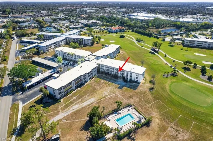 Aerial overview of property's location with a local golf course and a large body of water
