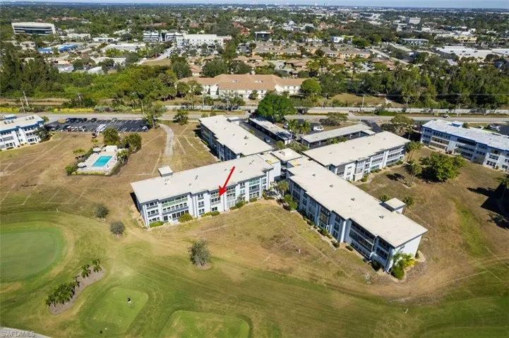 View of property location with apartment complex / building and a local golf course