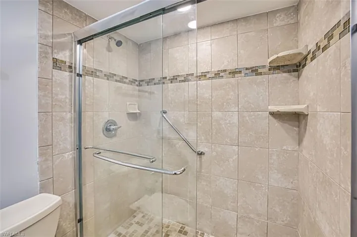Full bath with a stall shower and toilet