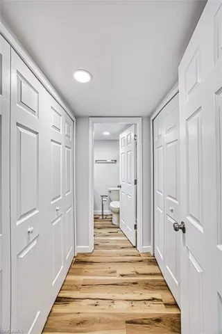 Hallway featuring light wood-style flooring and recessed lighting