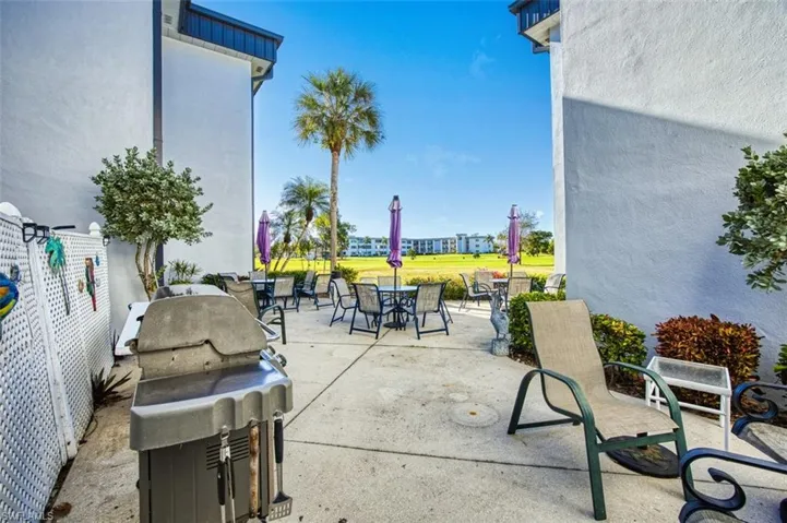 View of community patio / terrace featuring grilling area and outdoor dining area