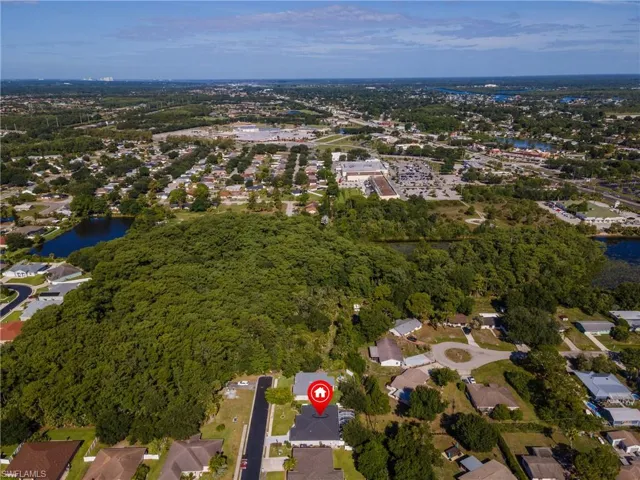Aerial perspective showcasing a residential neighborhood with substantial tree coverage
