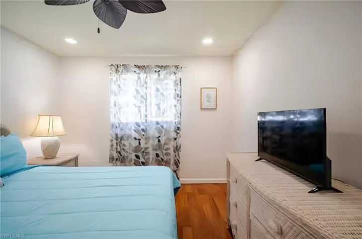 Bedroom featuring light wood-type flooring, a ceiling fan, and recessed lighting