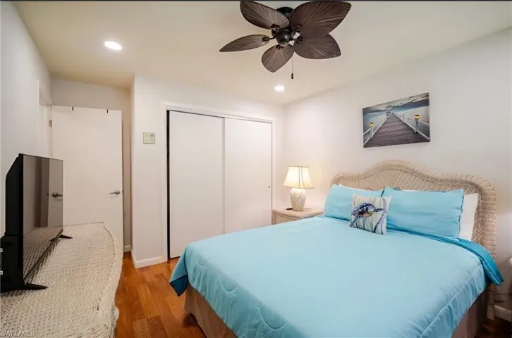 Bedroom featuring wood finished floors, recessed lighting, a closet, and a ceiling fan