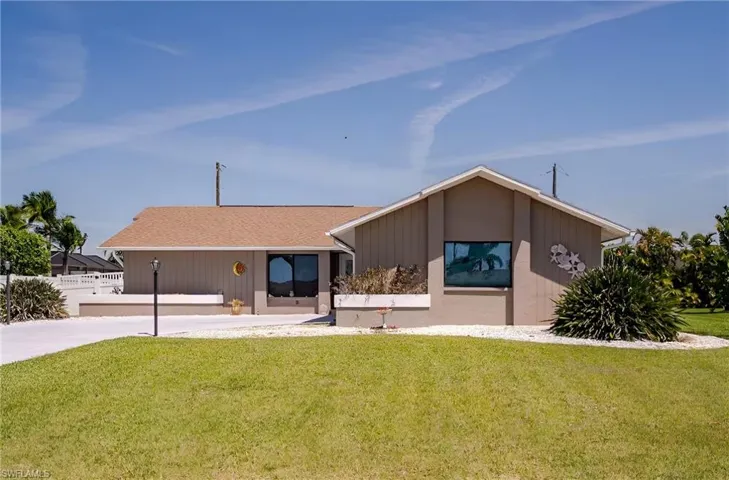 View of front of property with a shingled roof