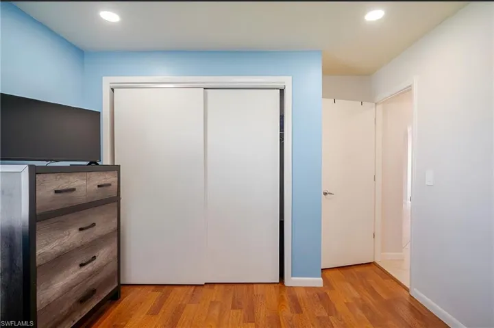 Unfurnished bedroom with recessed lighting, light wood-style floors, and a closet