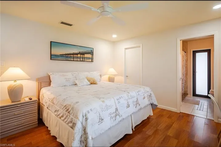 Bedroom featuring wood finished floors, ceiling fan, and recessed lighting