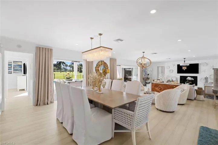 Dining room with a chandelier, light wood-type flooring, and recessed lighting