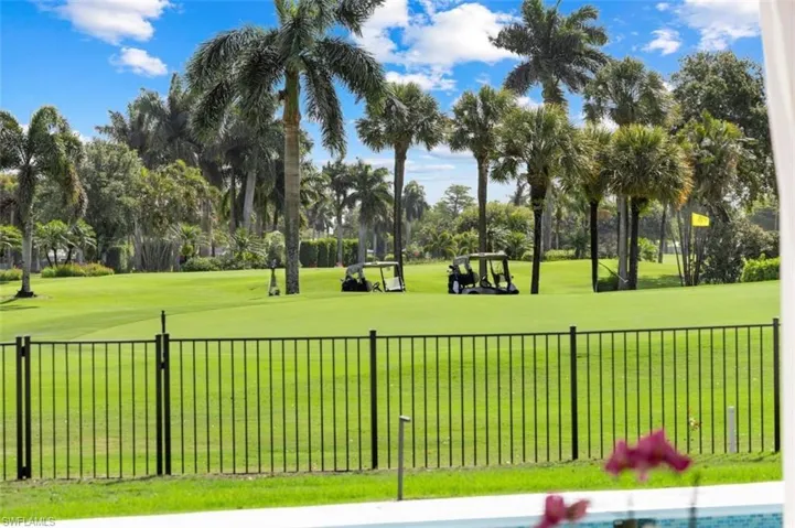 Surrounding community featuring view of wooded area and golf course view