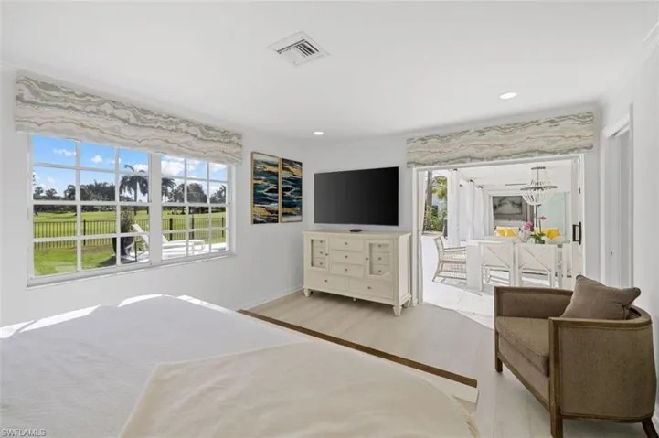 Bedroom featuring wood finished floors, access to outside, and recessed lighting