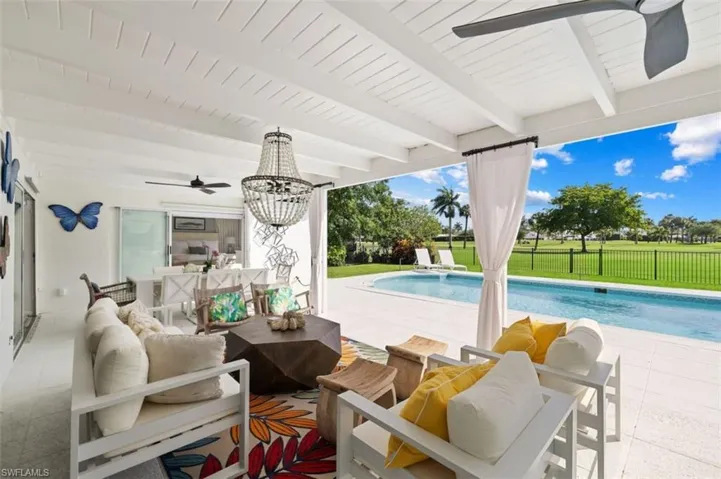 Outdoor pool with an outdoor living space and a patio area